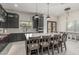 Kitchen island with bar stool seating, dark cabinetry, and a sleek white countertop at 7215 W Union Hills Dr, Glendale, AZ 85308