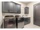 Laundry room with washer, dryer, sink, and storage at 7215 W Union Hills Dr, Glendale, AZ 85308
