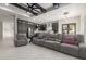 Open-concept living space showcasing a gray sectional sofa and seamless flow into the kitchen at 7215 W Union Hills Dr, Glendale, AZ 85308