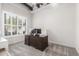 Home office is complete with a large desk, plantation shutters, neutral color scheme and carpet flooring at 7215 W Union Hills Dr, Glendale, AZ 85308