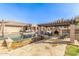 Stunning pool area with a stone-clad fireplace, pergola, and comfortable seating, creating a luxurious outdoor retreat at 7215 W Union Hills Dr, Glendale, AZ 85308