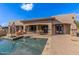 Backyard featuring a pool, patio area, and outdoor seating, perfect for relaxation and entertainment at 7215 W Union Hills Dr, Glendale, AZ 85308