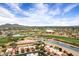 Scenic aerial view of a beautiful golf course community featuring lush landscaping, lakes, and stunning mountain views at 7818 E Cactus Wren Rd, Scottsdale, AZ 85250