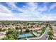 Overhead view of a desert community featuring well-maintained landscaping, a pool, and tennis courts at 7818 E Cactus Wren Rd, Scottsdale, AZ 85250