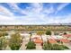 Scenic aerial view of the property showcasing lush landscaping, lake, and beautiful neighborhood with mountain views at 7818 E Cactus Wren Rd, Scottsdale, AZ 85250