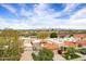 Aerial view capturing the community's terracotta roofs, manicured landscapes, and mountain views, showcasing its idyllic setting at 7818 E Cactus Wren Rd, Scottsdale, AZ 85250