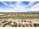 Expansive aerial view of the community and golf course, near a waterway, with mountain views at 7818 E Cactus Wren Rd, Scottsdale, AZ 85250