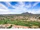Sprawling desert golf community, highlighting lush green golf courses and stunning mountain views at 7818 E Cactus Wren Rd, Scottsdale, AZ 85250
