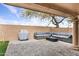 Cozy covered patio with an outdoor sectional sofa and grill area, creating a relaxing outdoor living experience at 7818 E Cactus Wren Rd, Scottsdale, AZ 85250
