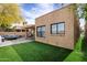 A backyard featuring artificial turf, a paver patio, and a contemporary outdoor seating area, creating an inviting outdoor living space at 7818 E Cactus Wren Rd, Scottsdale, AZ 85250