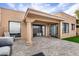 Covered patio with a gray wicker sectional sofa and a paver patio, seamlessly integrating indoor and outdoor spaces at 7818 E Cactus Wren Rd, Scottsdale, AZ 85250