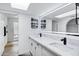 Modern bathroom featuring double sinks, quartz countertops, and a walk-in shower with marble tile at 7818 E Cactus Wren Rd, Scottsdale, AZ 85250