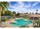 Community pool surrounded by lush greenery, lounge chairs, and inviting gazebo, providing a resort-style recreation area at 7818 E Cactus Wren Rd, Scottsdale, AZ 85250
