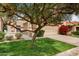 Charming single-story home featuring a tile roof, two-car garage, and well-maintained landscaping at 7818 E Cactus Wren Rd, Scottsdale, AZ 85250