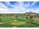 Golf course aerial view featuring undulating greens and mature trees in a beautiful desert setting at 7818 E Cactus Wren Rd, Scottsdale, AZ 85250