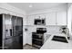 Elegant kitchen with a stainless steel refrigerator, updated appliances, and a marble countertop at 7818 E Cactus Wren Rd, Scottsdale, AZ 85250