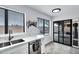 Modern kitchen featuring a stainless steel sink, granite countertops, and sliding glass doors to the patio at 7818 E Cactus Wren Rd, Scottsdale, AZ 85250