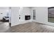 Open living room with wood-look flooring and a fireplace, perfect for relaxing and entertaining at 7818 E Cactus Wren Rd, Scottsdale, AZ 85250
