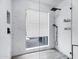 Sleek shower with black fixtures and a large window providing natural light and views at 7818 E Cactus Wren Rd, Scottsdale, AZ 85250