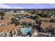 Overhead view of a condo community with a pool surrounded by red-tiled roofs and lush landscaping at 839 S Westwood Rd # 253, Mesa, AZ 85210