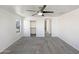 Spacious bedroom featuring carpeted floors, white walls, a ceiling fan, and bright window views at 842 E Beverly Rd, Phoenix, AZ 85042
