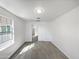 Clean bedroom with gray carpet, white walls, natural light, and a door leading to a closet at 842 E Beverly Rd, Phoenix, AZ 85042
