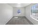 Bright, carpeted bedroom with two windows, featuring neutral walls and ample natural light at 842 E Beverly Rd, Phoenix, AZ 85042