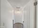 Hallway featuring neutral walls, an overhead light, a decorative floor design, and an open doorway at 842 E Beverly Rd, Phoenix, AZ 85042