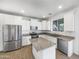 Modern kitchen featuring white cabinets, granite countertops, stainless steel appliances, and an island at 842 E Beverly Rd, Phoenix, AZ 85042