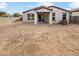 Backyard with covered patio, ready for landscaping, and block wall fencing for privacy at 8886 S 256Th Dr, Buckeye, AZ 85326