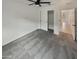 Bedroom featuring a ceiling fan, gray carpet, and an open closet for ample storage at 8886 S 256Th Dr, Buckeye, AZ 85326