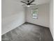 This carpeted bedroom offers neutral paint and natural light from the window, a comfortable space at 8886 S 256Th Dr, Buckeye, AZ 85326