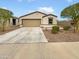 Charming single-story home with a neutral color scheme, two-car garage, and low-maintenance desert landscaping at 8886 S 256Th Dr, Buckeye, AZ 85326
