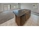 Open kitchen with an island, dishwasher, and a view to the carpeted living room at 8886 S 256Th Dr, Buckeye, AZ 85326