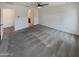 Spacious living room featuring carpeted floors and a glimpse into the bathroom at 8886 S 256Th Dr, Buckeye, AZ 85326
