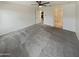 Spacious main bedroom with gray carpet, ceiling fan, and ensuite bathroom at 8886 S 256Th Dr, Buckeye, AZ 85326