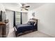 Comfortable bedroom with ceiling fan, dresser, and natural light from a large window at 9700 E Harvest Rd, Florence, AZ 85132