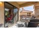 Cozy balcony with seating and view of the community, accessible through a sliding glass door at 9711 E Mountain View Rd # 2524, Scottsdale, AZ 85258