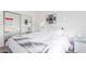 Bright bedroom featuring a bed with white bedding, bedside table, and zebra-striped artwork at 9711 E Mountain View Rd # 2524, Scottsdale, AZ 85258