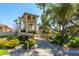 Racquet Club entrance showcases a two-story tower with beautiful landscaping and architectural details at 9711 E Mountain View Rd # 2524, Scottsdale, AZ 85258