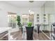 Dining area with glass table, modern lighting, view to the patio and mirrored wall at 9711 E Mountain View Rd # 2524, Scottsdale, AZ 85258