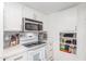 Well-lit kitchen showcasing stainless steel appliances, white cabinets and backsplash at 9711 E Mountain View Rd # 2524, Scottsdale, AZ 85258