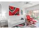 Comfortable living room with a white sofa, red accent chair, and access to a balcony through sliding glass doors at 9711 E Mountain View Rd # 2524, Scottsdale, AZ 85258