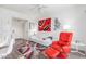 Bright living room featuring a comfortable white sofa, stylish red chair, and modern decor, creating a relaxing atmosphere at 9711 E Mountain View Rd # 2524, Scottsdale, AZ 85258