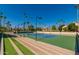 Well-maintained tennis court surrounded by palm trees and beautiful landscaping at 9711 E Mountain View Rd # 2524, Scottsdale, AZ 85258
