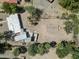 Bird's eye view of a private lot and a single Gathering house with outbuildings at 100 Swilling Ave, Wickenburg, AZ 85390