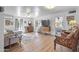 Bright living room with laminate floors, neutral walls, ceiling fans, and open doorways to other rooms at 100 Swilling Ave, Wickenburg, AZ 85390