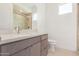 Bright bathroom with gray vanity, white countertop, and glass-enclosed shower stall at 10302 E Utah Ave, Mesa, AZ 85212