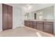 Elegant bathroom with a double sink vanity, plenty of storage, and a large mirror at 10302 E Utah Ave, Mesa, AZ 85212