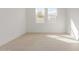 Sunlit bedroom with tile floors and crisp white walls; a minimalist and bright space at 10302 E Utah Ave, Mesa, AZ 85212